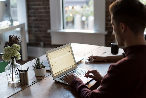 A man working on his laptop at a desk